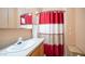 Bathroom featuring vanity storage and shower with red and white curtain at 834 S Beryl Dr, Apache Junction, AZ 85119