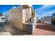 Tan home with AC unit and red paver walkway at 834 S Beryl Dr, Apache Junction, AZ 85119