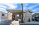 Charming home featuring a carport, palm trees, and desert landscaping at 834 S Beryl Dr, Apache Junction, AZ 85119