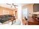 Cozy living room with a leather sofa, ceiling fan, and a decorative area rug at 834 S Beryl Dr, Apache Junction, AZ 85119