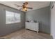 Bedroom with wood floors, a ceiling fan, a window with blinds and a chest of drawers at 8750 W Kingman St, Tolleson, AZ 85353