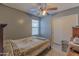 Cozy bedroom featuring wood look floors and natural light from the window at 8750 W Kingman St, Tolleson, AZ 85353