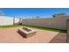 Backyard features an outdoor fire pit, artificial turf, and privacy walls; ideal for entertaining and relaxing at 9001 S 18Th Way, Phoenix, AZ 85042