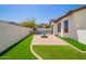 Backyard featuring a pool, patio, and well-maintained artificial grass at 9001 S 18Th Way, Phoenix, AZ 85042