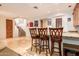 Home wet bar featuring a stone countertop, seating for three, and decorative wall decor at 9001 S 18Th Way, Phoenix, AZ 85042