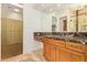 Bathroom boasts dual sinks with marble counters and a tiled glass shower enclosure at 9001 S 18Th Way, Phoenix, AZ 85042