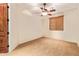 Bedroom showcasing a ceiling fan, a window and neutral-colored walls at 9001 S 18Th Way, Phoenix, AZ 85042