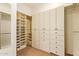 Walk-in closet with ample built-in shelving and drawer space for storage at 9001 S 18Th Way, Phoenix, AZ 85042