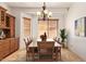Elegant dining room with wooden table set, stylish chandelier, and built-in cabinet at 9001 S 18Th Way, Phoenix, AZ 85042