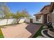 Paver patio and stone water feature along stucco privacy wall; accent lighting and desert landscaping at 9001 S 18Th Way, Phoenix, AZ 85042