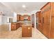 Gourmet kitchen with custom wood cabinets, granite counters, travertine floors and stainless steel appliances at 9001 S 18Th Way, Phoenix, AZ 85042