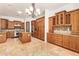 Gourmet kitchen with custom wood cabinets, travertine floors, granite counters and stainless steel appliances at 9001 S 18Th Way, Phoenix, AZ 85042