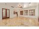 Spacious living area featuring travertine floors and seamless access to the kitchen at 9001 S 18Th Way, Phoenix, AZ 85042