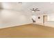 Open-concept living room with neutral carpet and recessed lighting at 9001 S 18Th Way, Phoenix, AZ 85042
