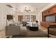 Staged living area featuring travertine floors, custom built-ins, and an open layout at 9001 S 18Th Way, Phoenix, AZ 85042