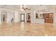 Open-concept living space features travertine floors, and seamless access to the kitchen at 9001 S 18Th Way, Phoenix, AZ 85042