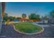 Expansive backyard featuring a pool with water features, lounge seating, and ambient string lights at 9388 W Cashman Dr, Peoria, AZ 85383
