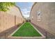 Narrow backyard with manicured lawn, gravel border, and privacy fencing for a low-maintenance outdoor space at 9388 W Cashman Dr, Peoria, AZ 85383
