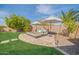 Outdoor lounge area with comfortable seating, umbrellas, and lush landscaping provides a serene escape at 9388 W Cashman Dr, Peoria, AZ 85383