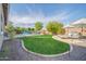 Expansive backyard with manicured lawn, sparkling pool, and inviting lounge areas for ultimate relaxation at 9388 W Cashman Dr, Peoria, AZ 85383