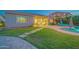 Spacious backyard featuring a pool, manicured lawn, a covered patio, and stepping stone pathway at 9388 W Cashman Dr, Peoria, AZ 85383