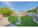 Lush backyard featuring manicured lawn, stone pathway, and an outdoor lounge area for relaxation at 9388 W Cashman Dr, Peoria, AZ 85383