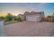 Beautiful home showcasing a paved driveway, a two-car garage, desert landscaping, and lush greenery at 9388 W Cashman Dr, Peoria, AZ 85383