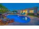 A serene pool surrounded by lounge chairs and lush landscaping, creating a perfect backyard retreat at 9388 W Cashman Dr, Peoria, AZ 85383
