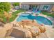 Resort-style pool with rock waterfall, slide, and lounge chairs offer a relaxing backyard retreat at 9388 W Cashman Dr, Peoria, AZ 85383
