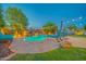 Backyard pool with baja shelf, rock waterfall feature, desert landscaping, lounge seating and outdoor lighting at 9388 W Cashman Dr, Peoria, AZ 85383