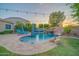 Luxurious pool with a tranquil waterfall feature, surrounded by lush landscaping, perfect for relaxation at 9388 W Cashman Dr, Peoria, AZ 85383