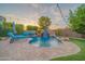 Gorgeous pool featuring stone accents, a waterfall feature, lounge seating and beautiful patio at 9388 W Cashman Dr, Peoria, AZ 85383