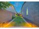 A well-manicured side yard with lighting, gravel, and pavers leading to the backyard at 9388 W Cashman Dr, Peoria, AZ 85383