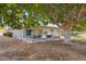 Single story home with a covered patio in a well-shaded backyard at 10303 W Desert Forest N Cir, Sun City, AZ 85351