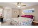 Comfortable bedroom featuring a ceiling fan and a sunlit window at 10303 W Desert Forest N Cir, Sun City, AZ 85351