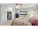 Bedroom featuring a bed with yellow patterned bedding, and an open closet with the sliding door open at 10303 W Desert Forest N Cir, Sun City, AZ 85351