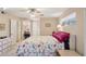 Bedroom with a queen-size bed, window, dresser, closet and desk along one wall of this living space at 10303 W Desert Forest N Cir, Sun City, AZ 85351