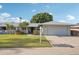 Charming single-story home featuring a well-manicured lawn and a two-car garage at 10303 W Desert Forest N Cir, Sun City, AZ 85351