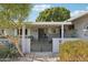 Charming single story home with a gated front porch and tidy landscaping at 10303 W Desert Forest N Cir, Sun City, AZ 85351