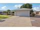 Spacious two-car garage with a concrete driveway and low-maintenance landscaping at 10303 W Desert Forest N Cir, Sun City, AZ 85351