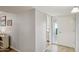 Hallway area featuring gray walls and tile flooring leading towards a kitchen and closet space at 10303 W Desert Forest N Cir, Sun City, AZ 85351