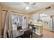 Eat-in kitchen area with stainless steel appliances, white cabinets, and a door to the outside patio at 10303 W Desert Forest N Cir, Sun City, AZ 85351