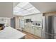 Bright kitchen featuring white cabinets, stainless steel appliances, and a light and airy atmosphere at 10303 W Desert Forest N Cir, Sun City, AZ 85351