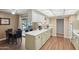 Modern kitchen with stainless steel appliances, white cabinets, and hardwood floors, perfect for cooking at 10303 W Desert Forest N Cir, Sun City, AZ 85351