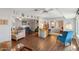 Open-concept living area featuring hardwood floors, comfortable seating, and bright, neutral wall colors at 10303 W Desert Forest N Cir, Sun City, AZ 85351