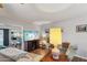 Cozy living room with hardwood floors, a large TV, and comfortable seating, perfect for relaxing at 10303 W Desert Forest N Cir, Sun City, AZ 85351