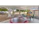Covered patio with chairs and a table, perfect for outdoor relaxation and entertaining at 10303 W Desert Forest N Cir, Sun City, AZ 85351