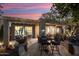 Elegant backyard featuring covered patio, desert landscaping, and ambient outdoor lighting at 12715 W Crestvale Dr, Peoria, AZ 85383