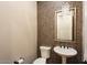Cozy half-bath featuring modern chandelier, mosaic accent wall, pedestal sink and toilet at 12715 W Crestvale Dr, Peoria, AZ 85383