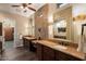 A spacious bathroom features and sinks with a wall to wall mosaic tile design at 12715 W Crestvale Dr, Peoria, AZ 85383